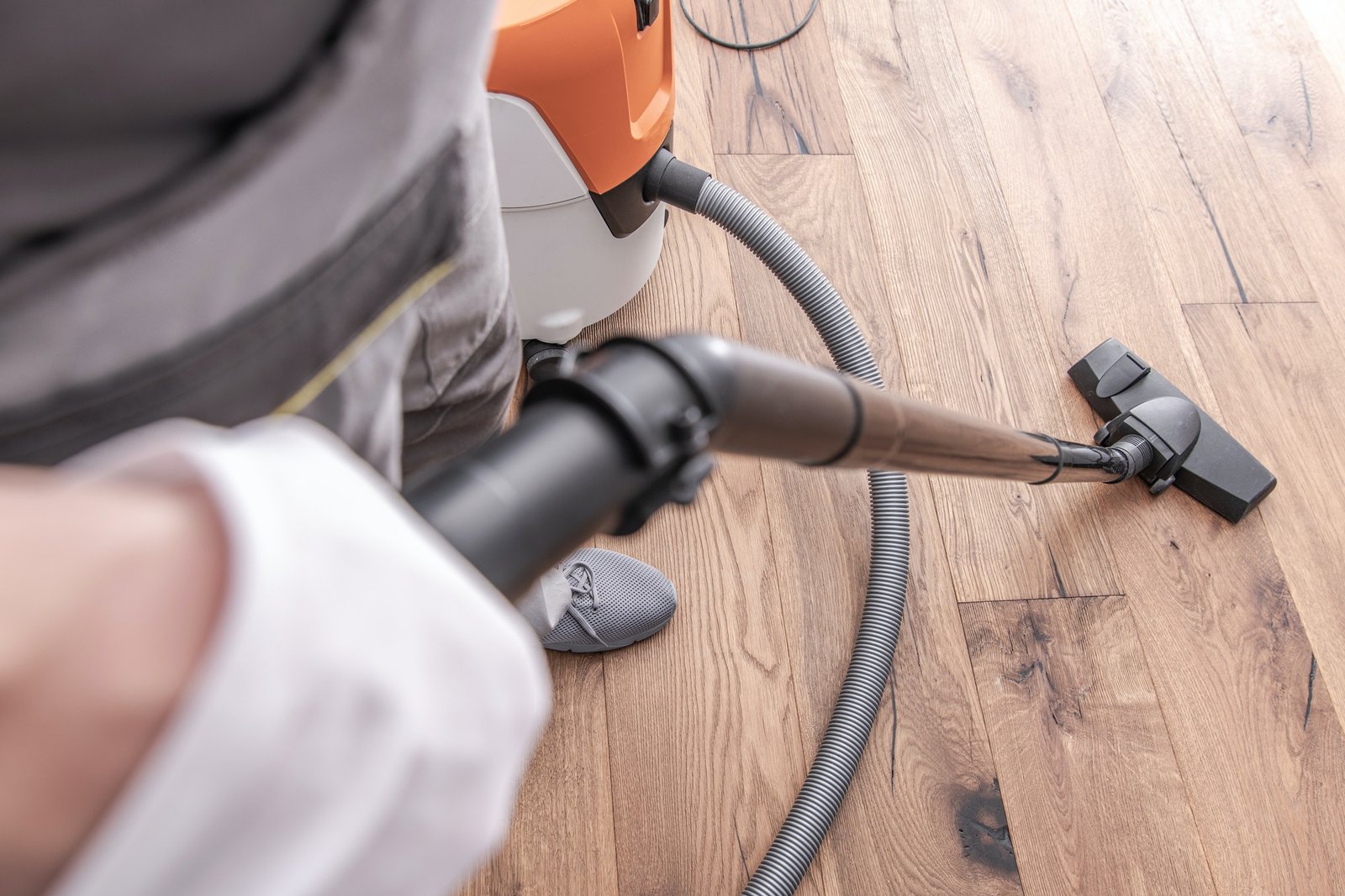 male-worker-vacuuming-hardwood-flooring-.jpg